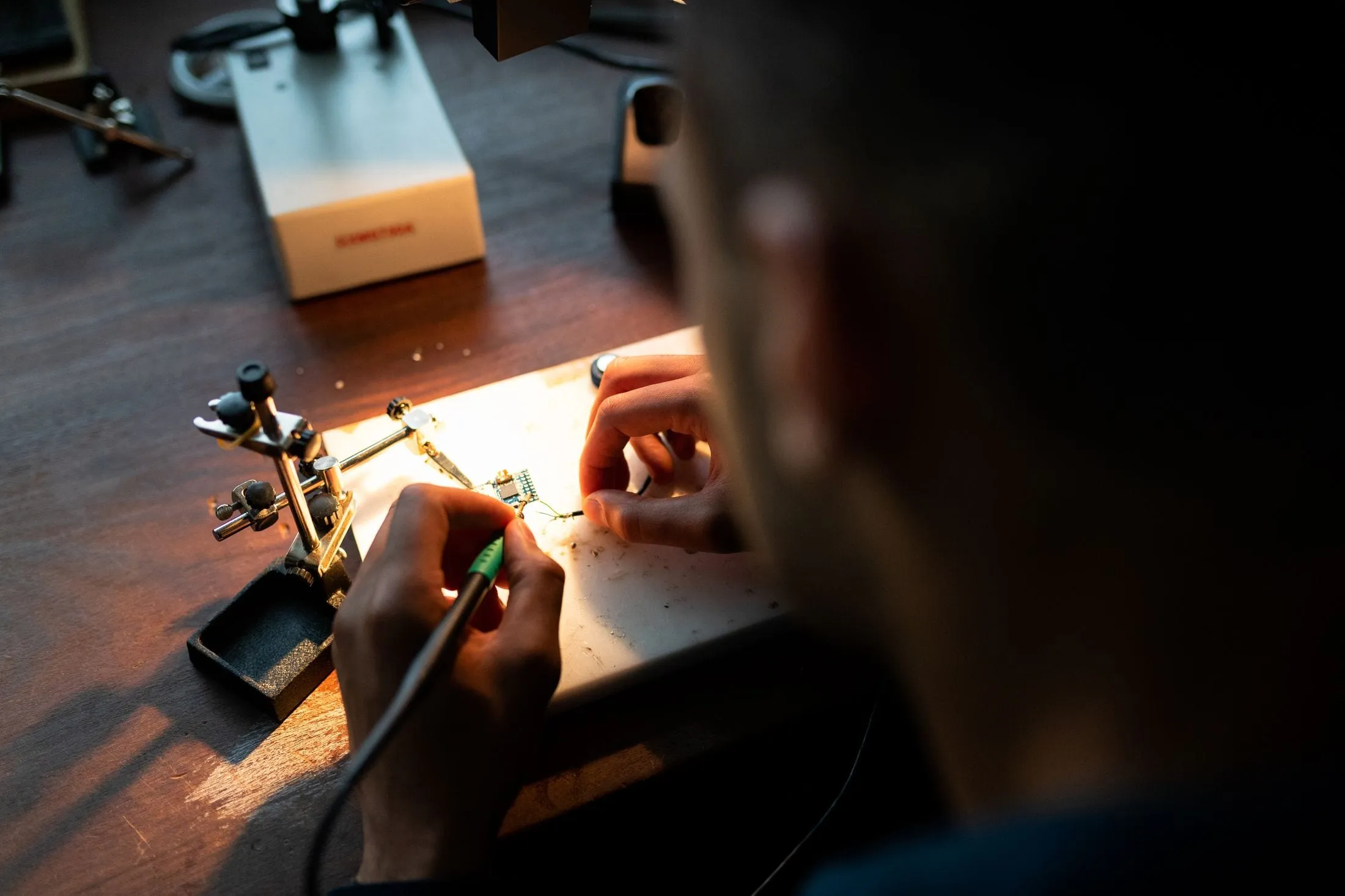 Engineer soldering a circuit board